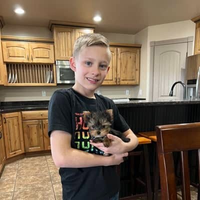 Boy holding Yorkie puppy